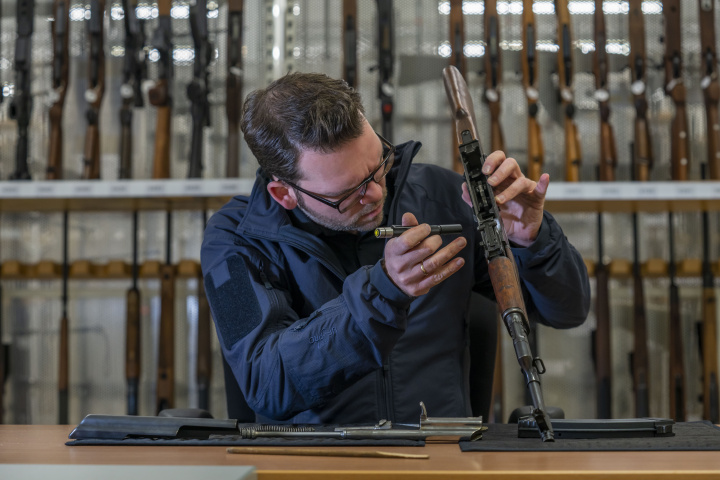 Sitting policeman assembling a rifle