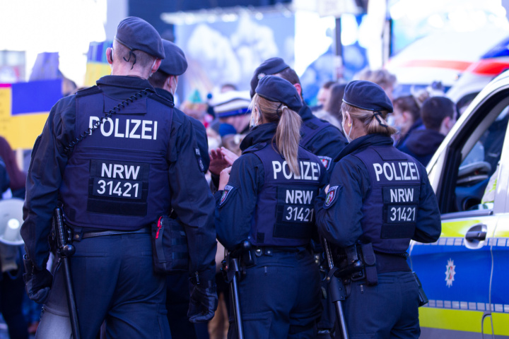 Police officers shield a peace demonstration