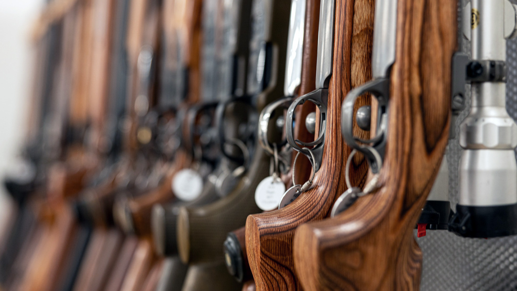 Several wooden rifles set up in a row